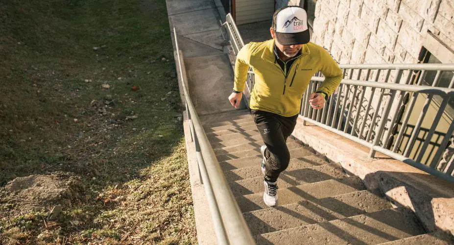 A man running up a set of stairs while wearing Supferfeet insoles.