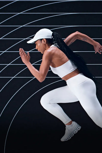 Woman running on a track with a black and white background